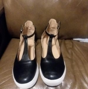 Black and white slip on shoes with ankle strap